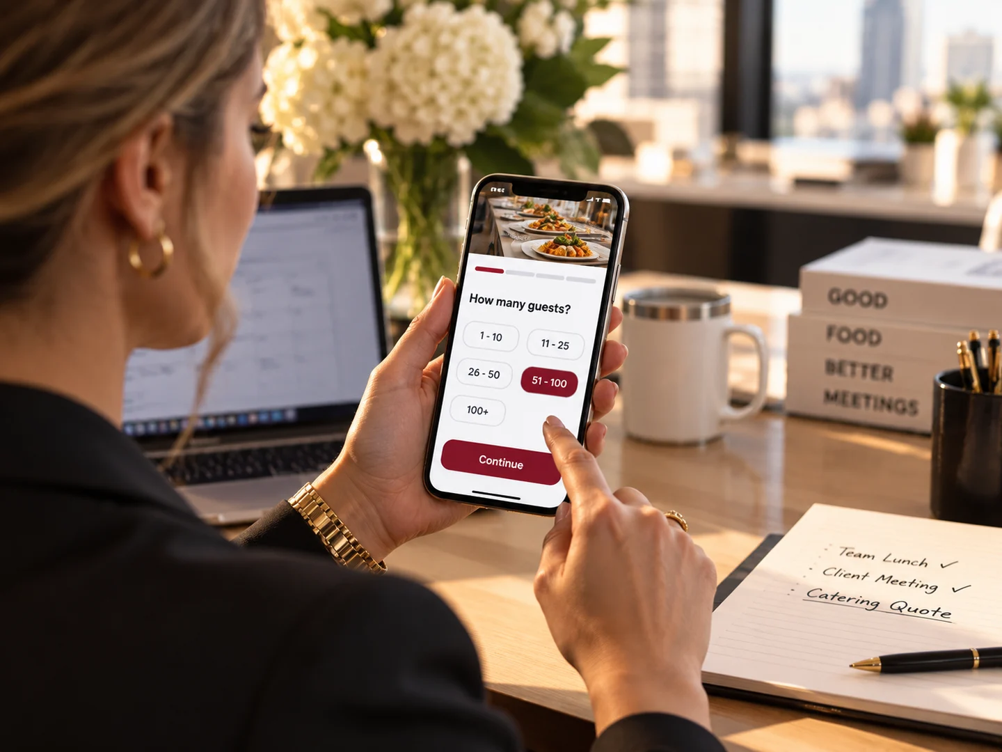 An office manager filling in a catering request form on her phone