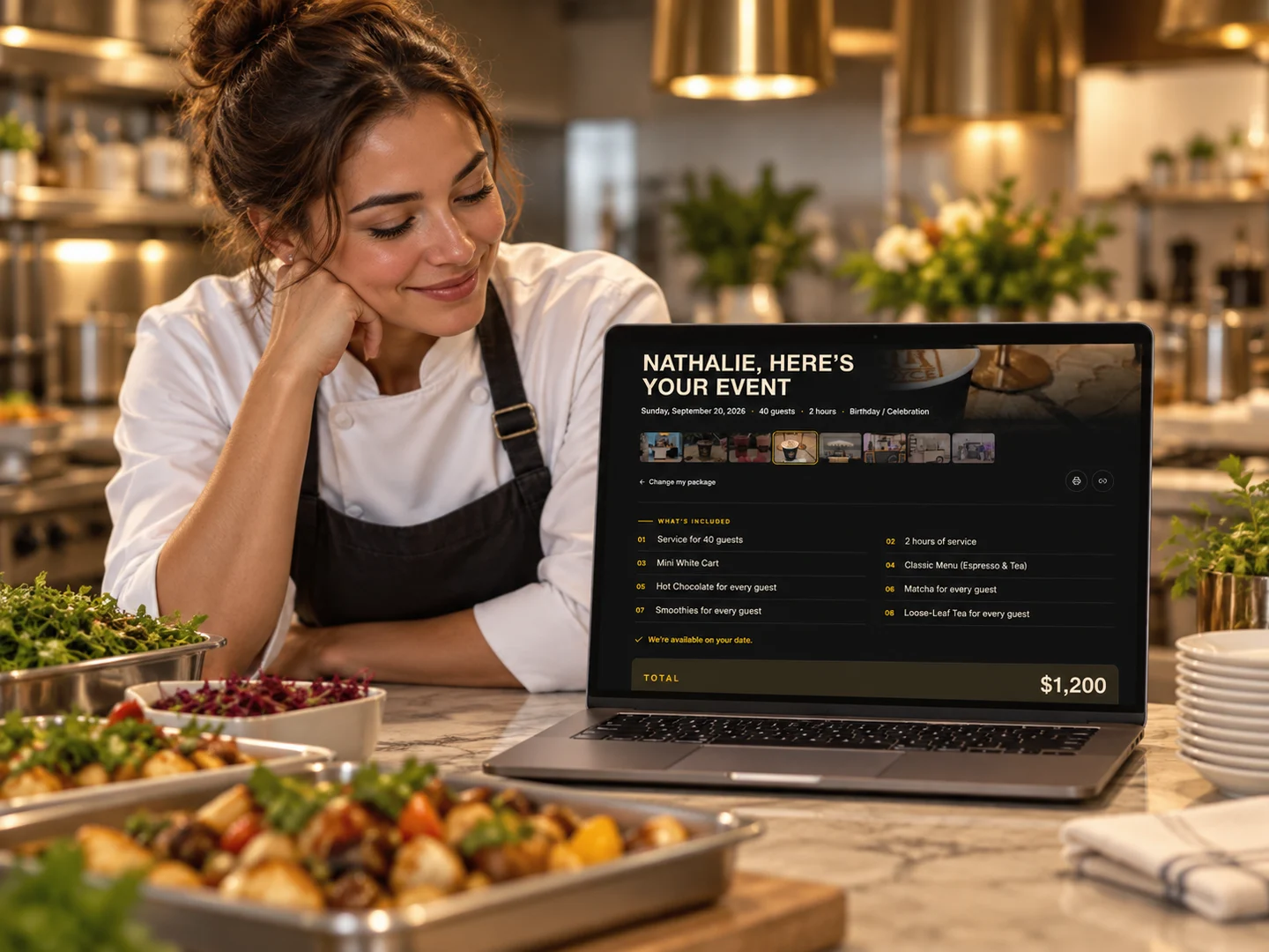 A chef beside catering trays reviewing a priced event package on a laptop