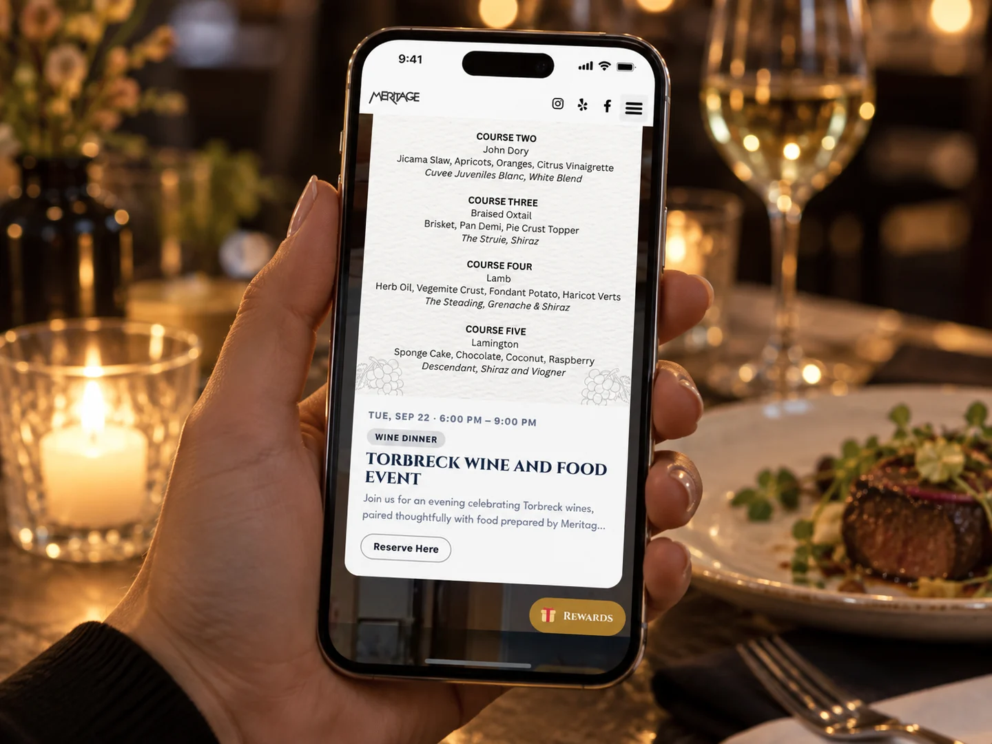 A guest reading a wine dinner event page on their phone at the table