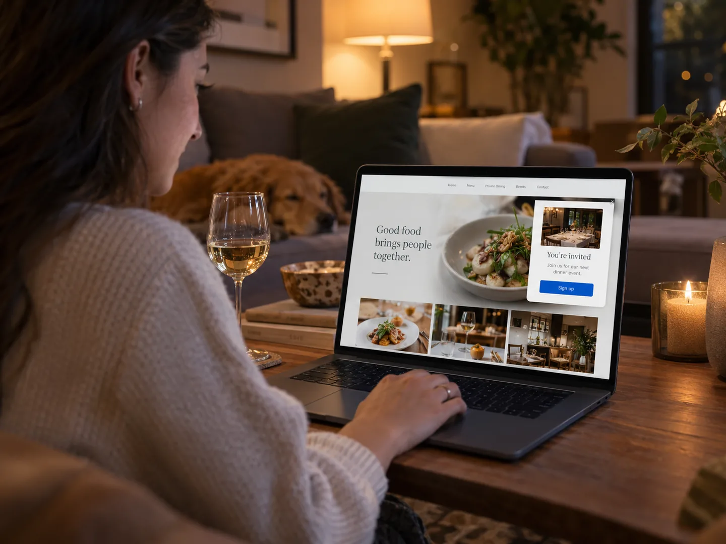 A guest at home on the sofa reading a restaurant’s website, invited to its next dinner event by a pop-up
