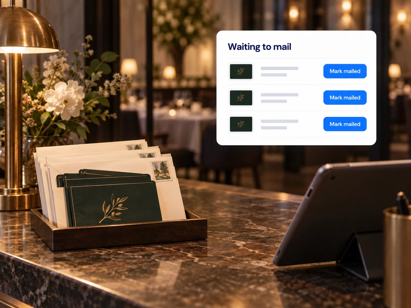 Gift cards in stamped envelopes at a host stand, beside a queue of cards waiting to mail