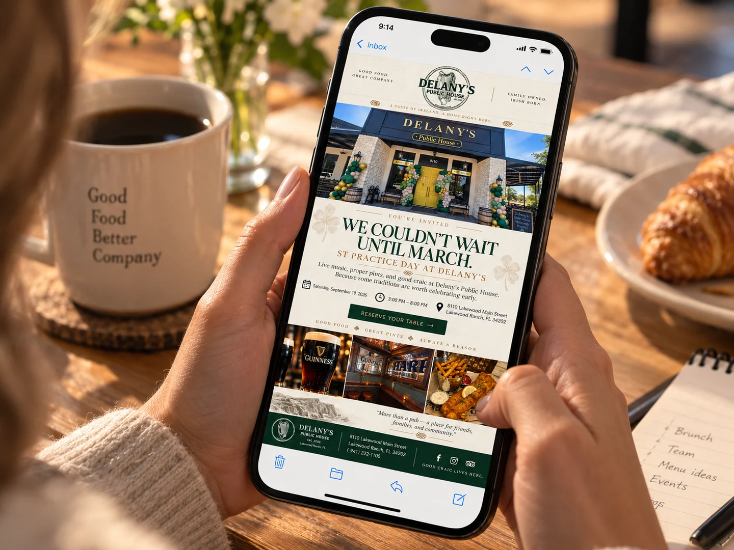 A guest reading a restaurant’s email on their phone over coffee