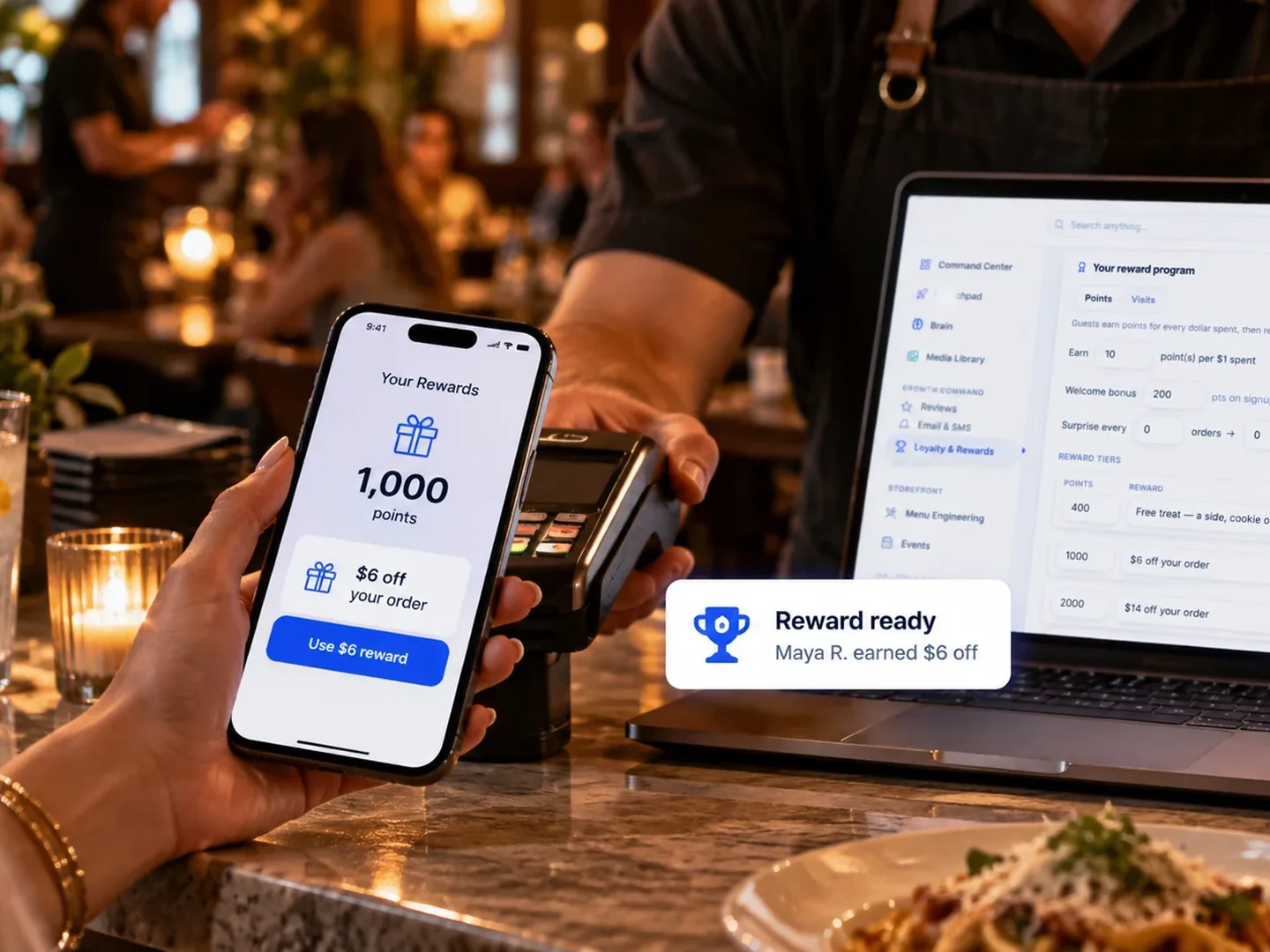 A guest using a reward on their phone at the counter, with the loyalty program open on a laptop