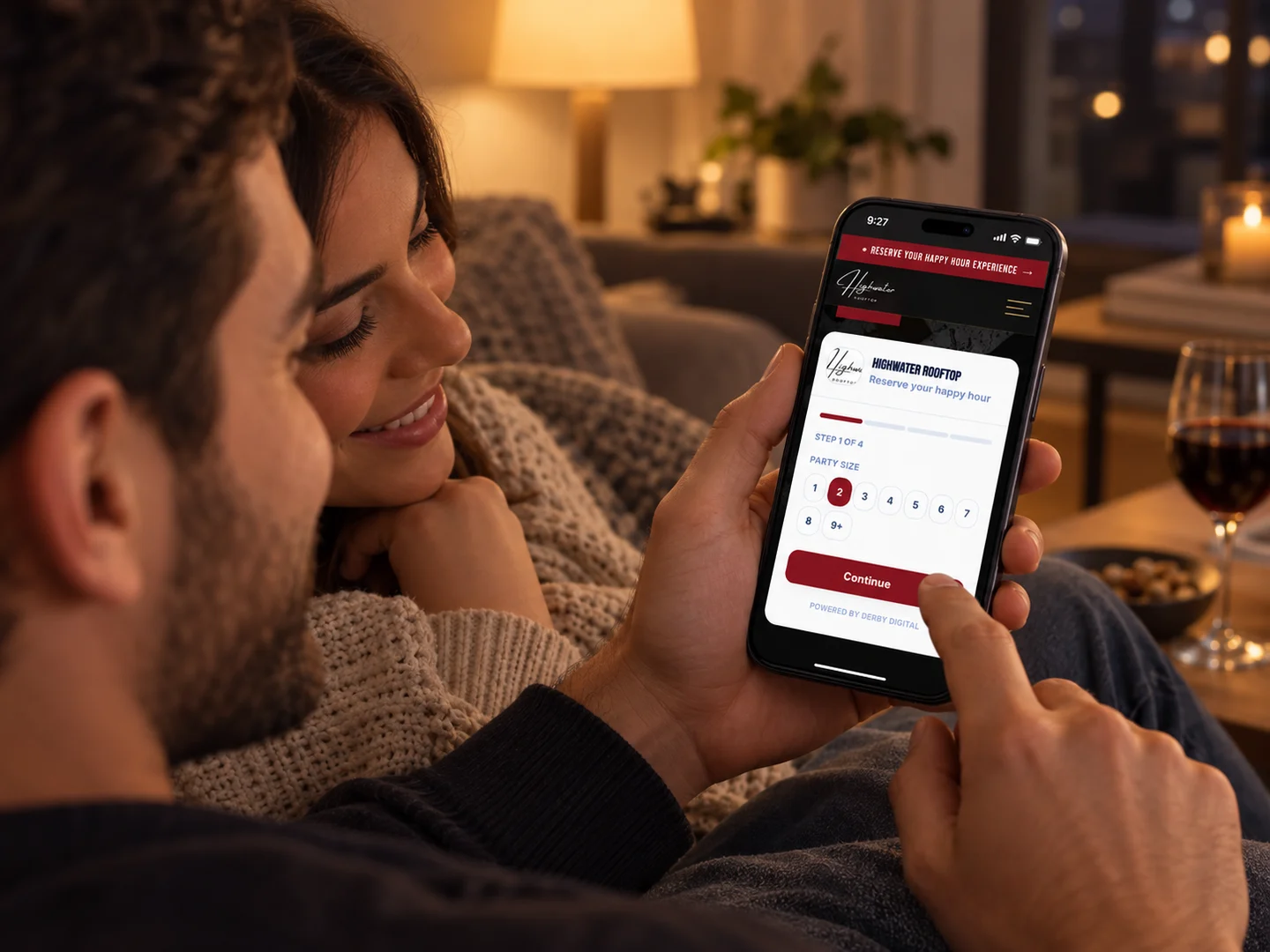 A couple at home booking a table on the restaurant’s own booking page