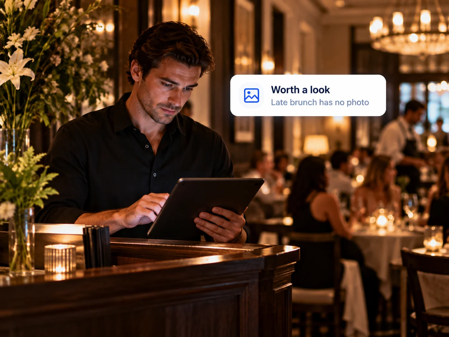 An owner at the host stand checking specials that need a photo on a tablet
