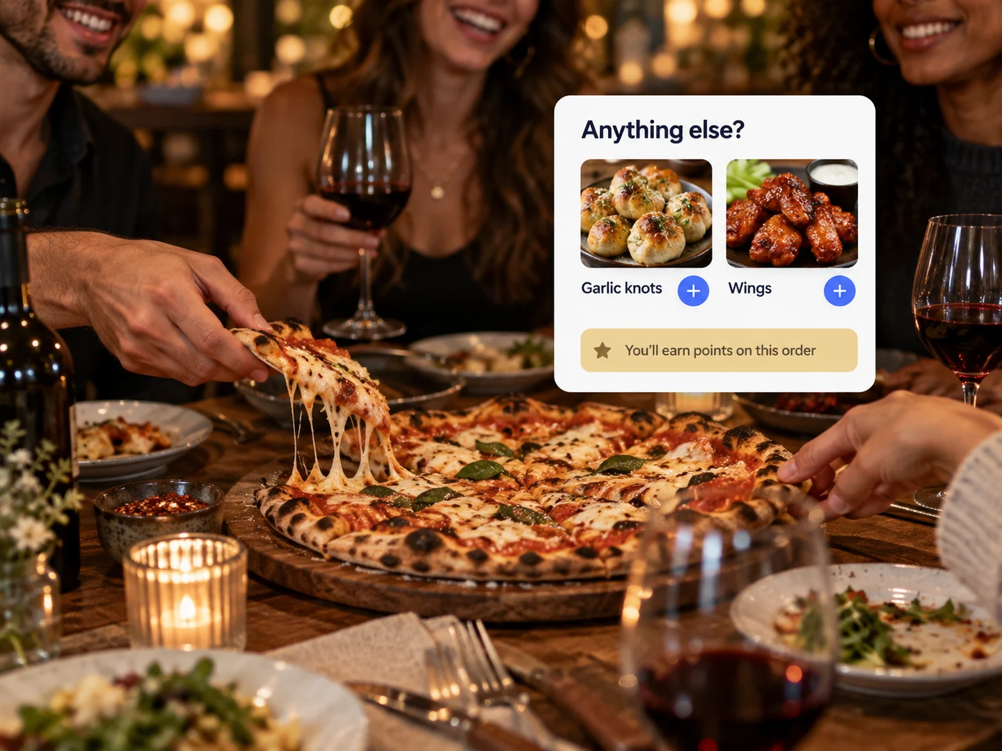 Friends sharing pizza and wine at a table, beside add-on suggestions and loyalty points