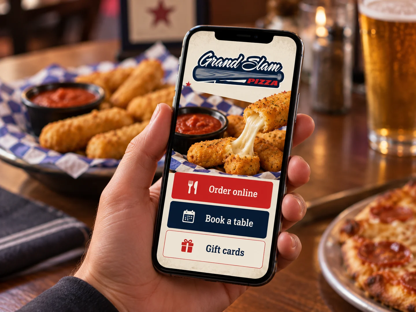 A phone showing a restaurant website with order online, book a table and gift card buttons