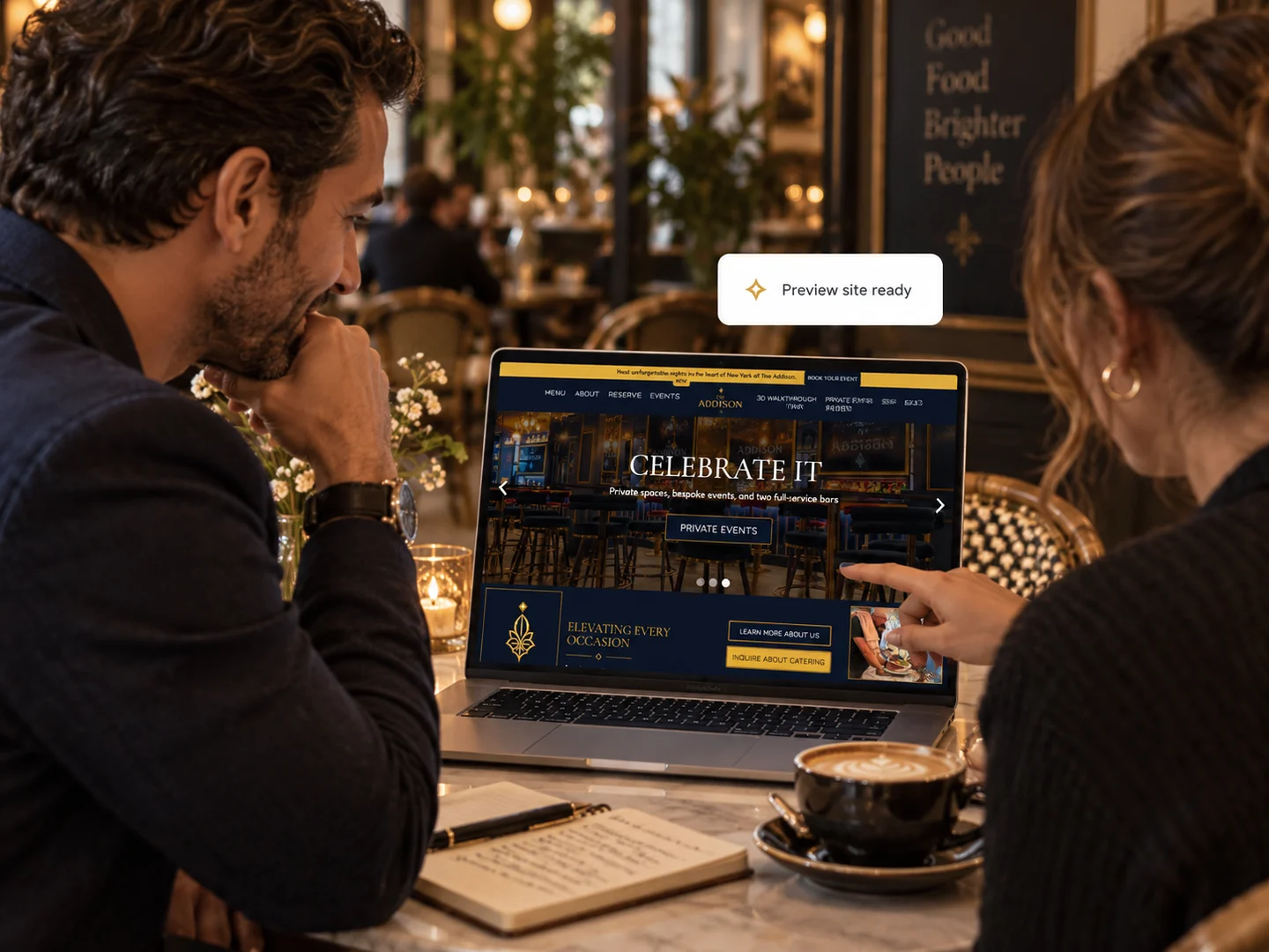 An owner and designer reviewing a restaurant’s new website together on a laptop